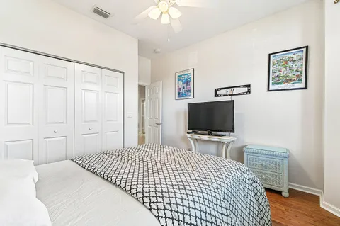 a bedroom with a bed and a flat screen tv