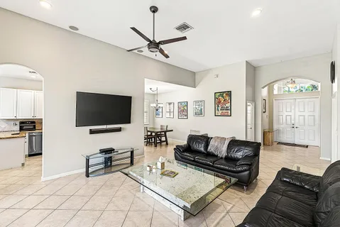 a living room with furniture and a flat screen tv