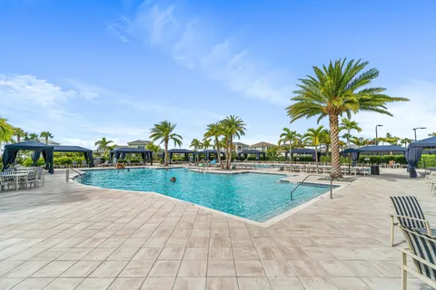 a view of swimming pool with outdoor seating and plants