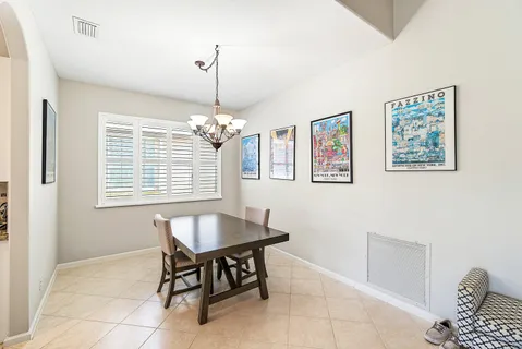 a dining room with furniture and window