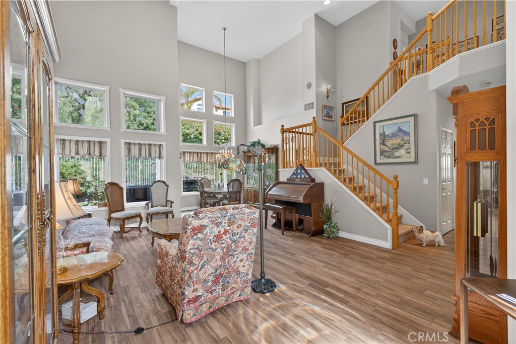 17 Vía Anadeja Rancho Santa Margarita, CA 92688 - Photo 15 of 43 a living room with furniture stairs and a wooden floor