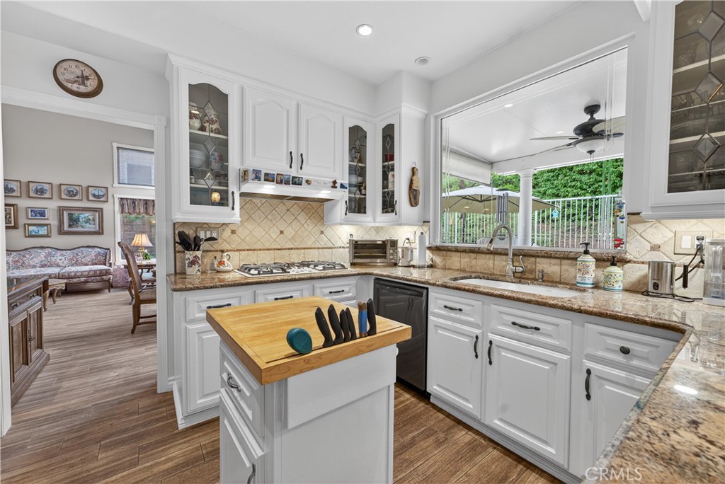 17 Vía Anadeja Rancho Santa Margarita, CA 92688 - Photo 20 of 43 a kitchen with a stove a sink a refrigerator and wooden cabinets