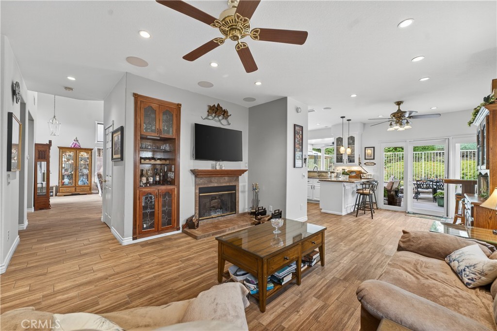17 Vía Anadeja Rancho Santa Margarita, CA 92688 - Photo 26 of 43 a living room with furniture a flat screen tv and kitchen view