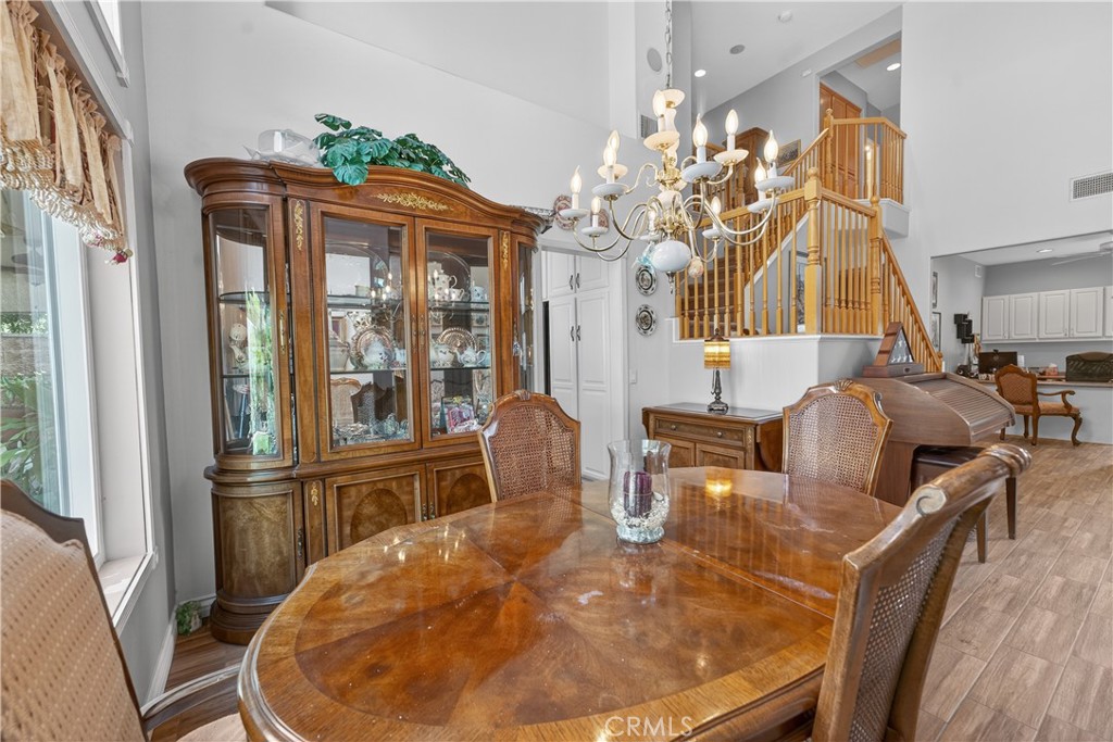 17 Vía Anadeja Rancho Santa Margarita, CA 92688 - Photo 27 of 43 a view of a dining room with furniture wooden floor and chandelier