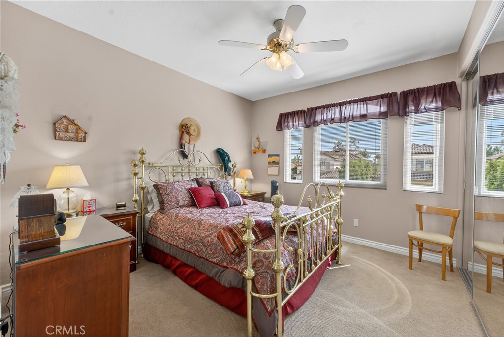 17 Vía Anadeja Rancho Santa Margarita, CA 92688 - Photo 40 of 43 a bed room with a bed and a chandelier