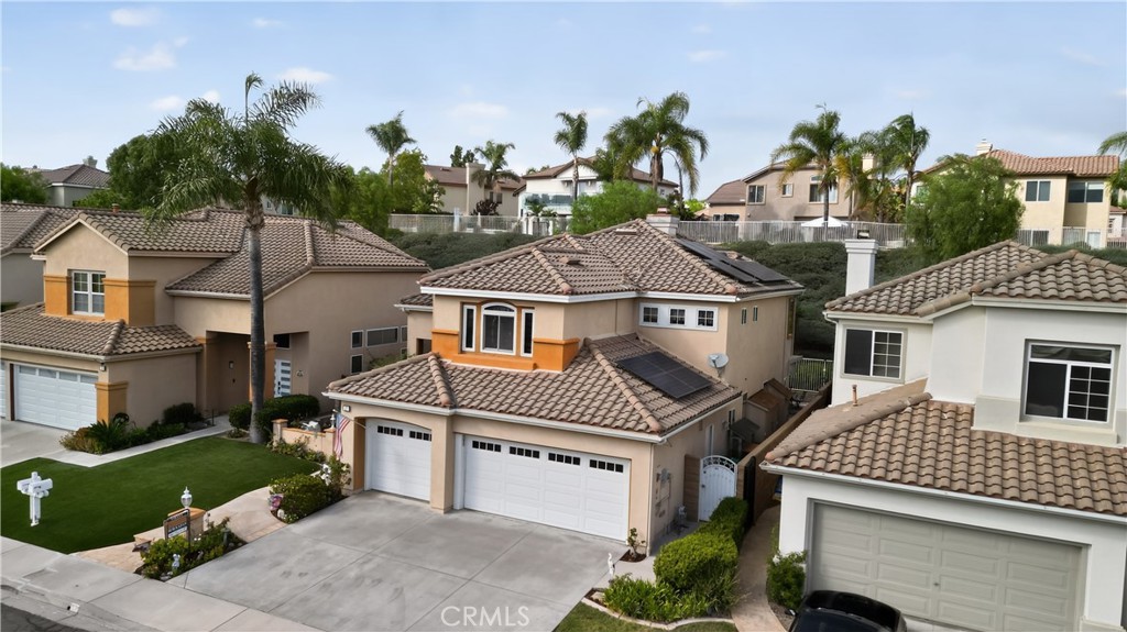 17 Vía Anadeja Rancho Santa Margarita, CA 92688 - Photo 4 of 43 a view of a white house with a yard and potted plants