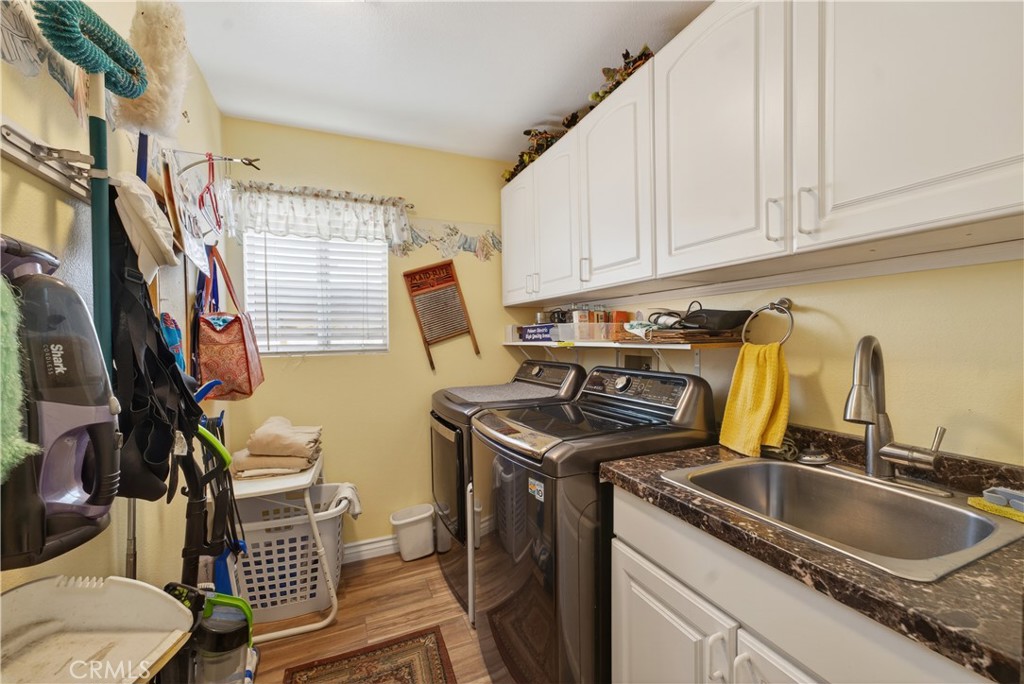 17 Vía Anadeja Rancho Santa Margarita, CA 92688 - Photo 41 of 43 a kitchen with granite countertop a sink a stove and cabinets