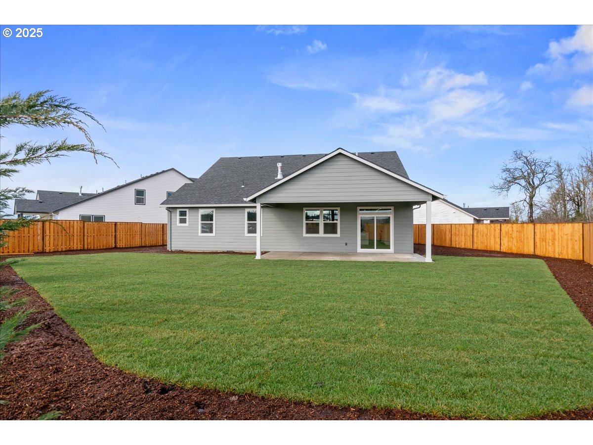 628 Parker Loop Silverton, OR 97381 - Photo 16 of 19 a view of a yard in front of a house with a large tree