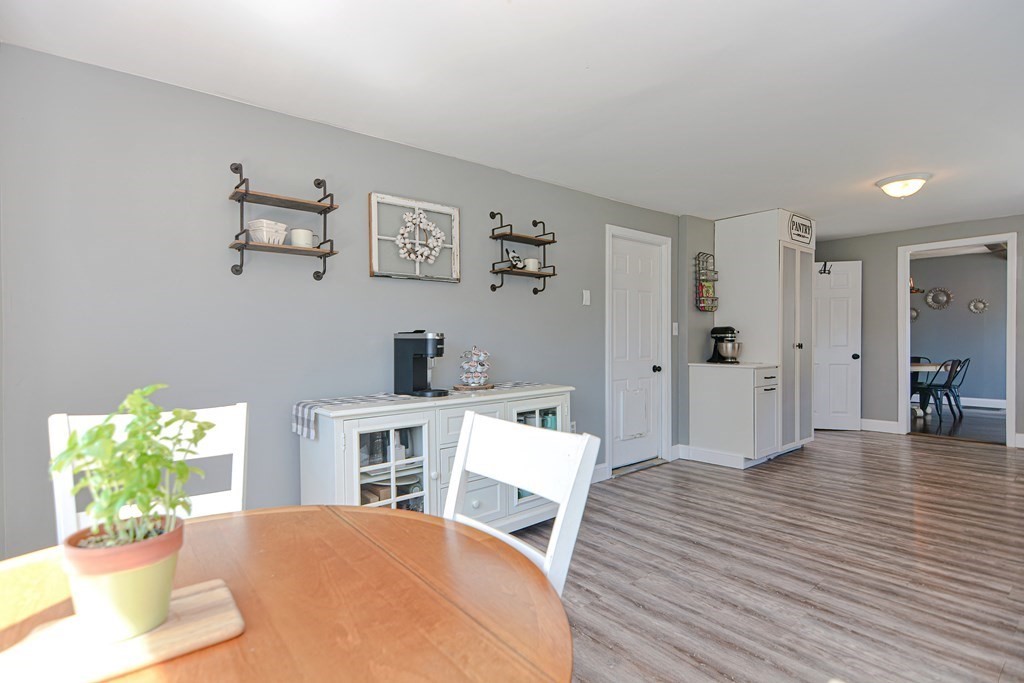 122 Mendon Road Sutton, MA 01590 - Photo 16 of 36 a view of a livingroom with furniture a dinning room and wooden floor