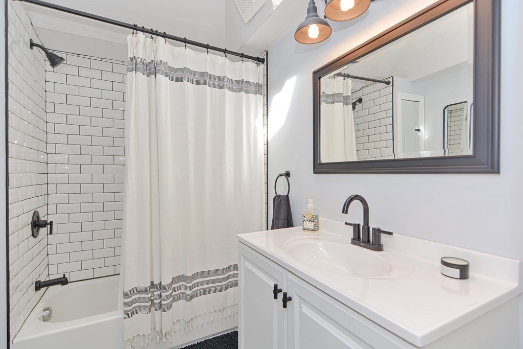 122 Mendon Road Sutton, MA 01590 - Photo 24 of 36 a bathroom with a sink a mirror a vanity and a shower