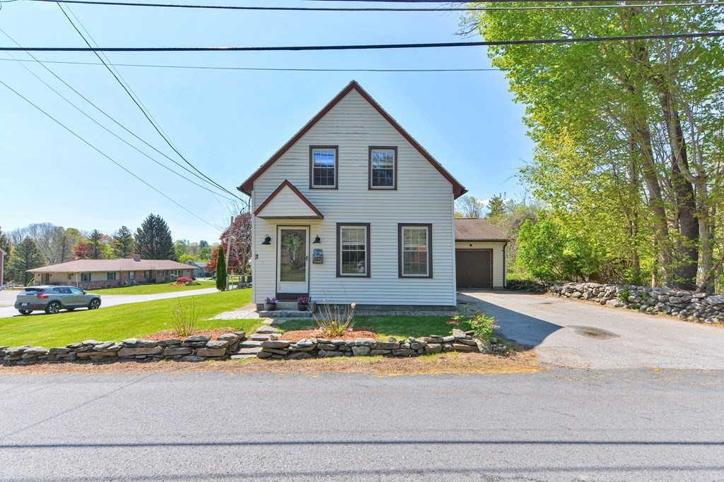 122 Mendon Road Sutton, MA 01590 - Photo 35 of 36 a front view of a house with a yard and garage