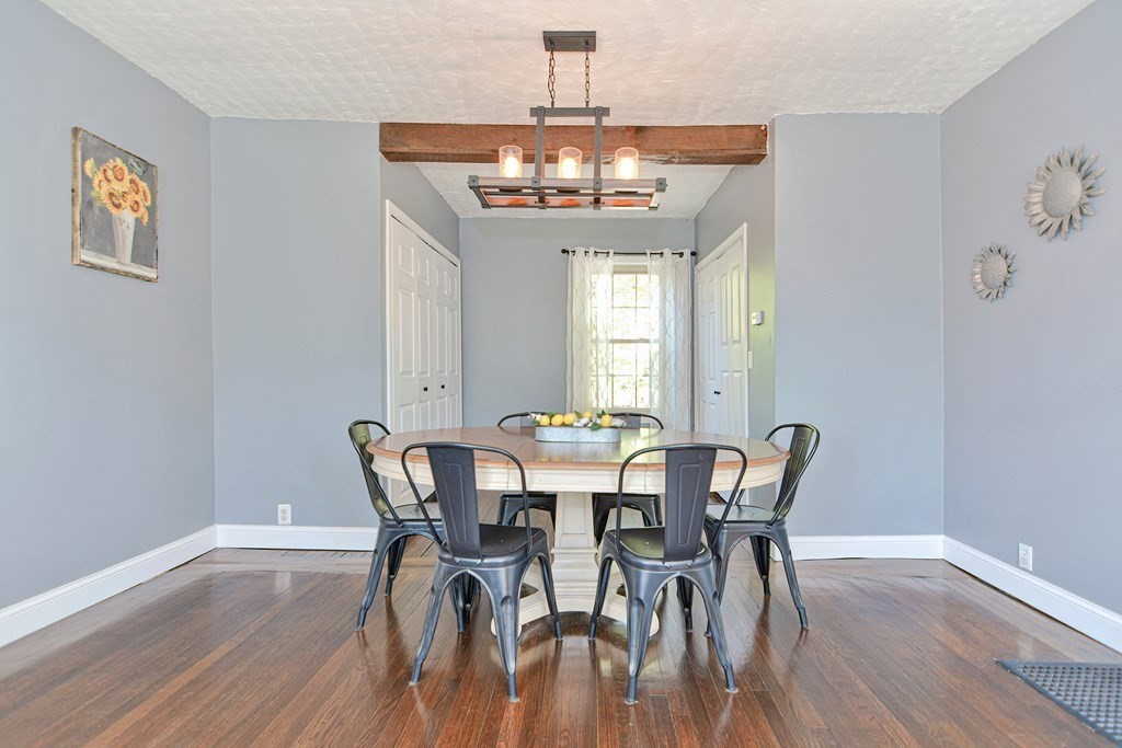 122 Mendon Road Sutton, MA 01590 - Photo 10 of 36 a view of a dining room with furniture a chandelier and wooden floor