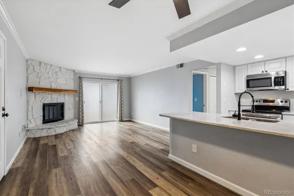 a view of kitchen with sink microwave and refrigerator