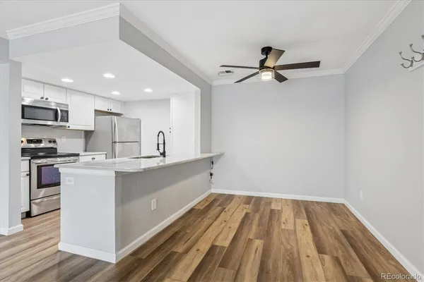 a kitchen with a sink stainless steel appliances and cabinets