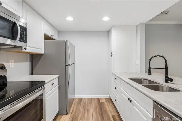 a kitchen with stainless steel appliances and a sink
