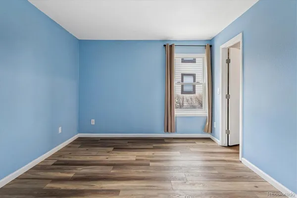 a view of room with window and wooden floor