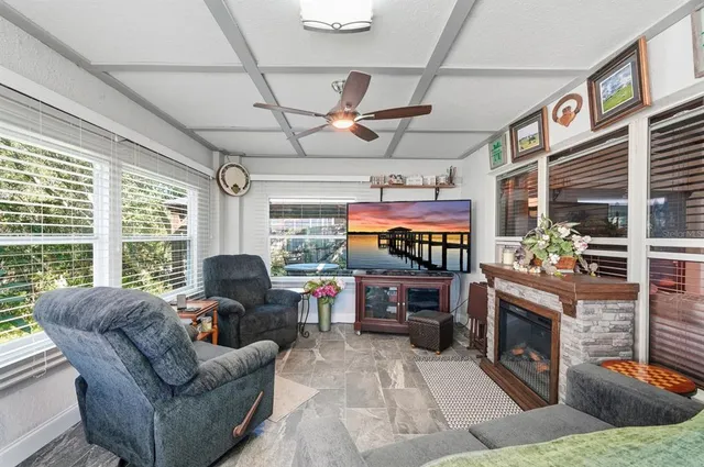 a living room with fireplace furniture and a floor to ceiling window