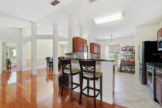 a view of a dining room with furniture and wooden floor