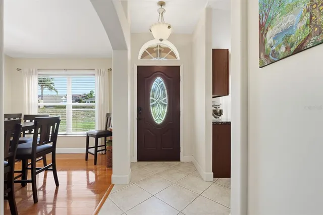 a dining room with furniture and a window