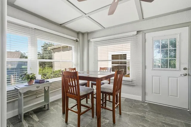 a dining room with furniture and windows
