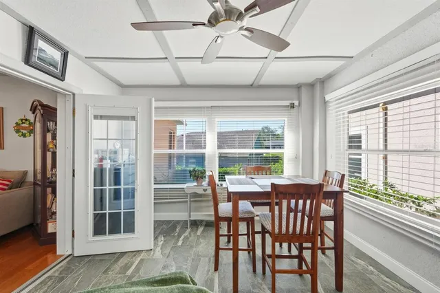 a view of a dining room with furniture large windows and wooden floor