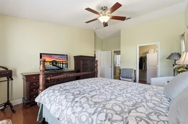 a bedroom with a large bed and a chandelier