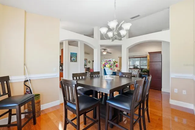 a view of a dining room with furniture and wooden floor