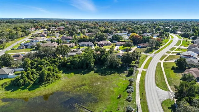 an aerial view of residential houses with outdoor space and swimming pool