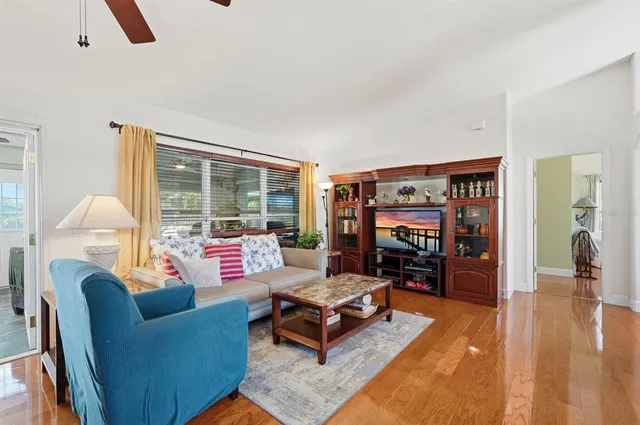 a living room with furniture and a wooden floor