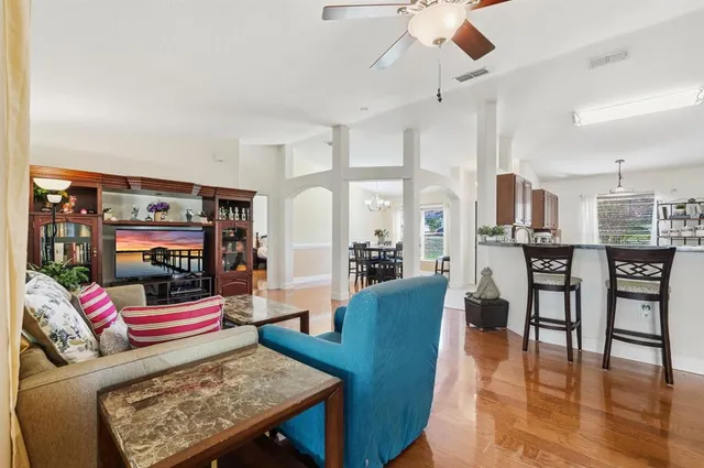 a living room with furniture and wooden floor