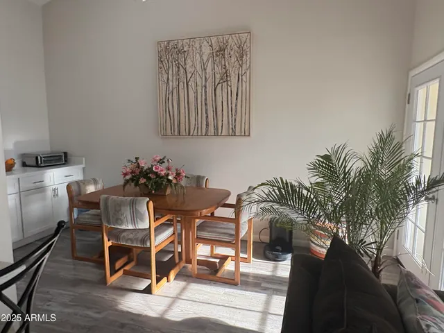 a dining room with furniture and wooden floor