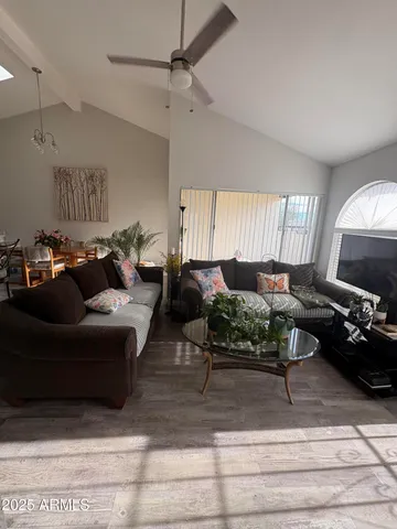 a living room with furniture a couch and a window