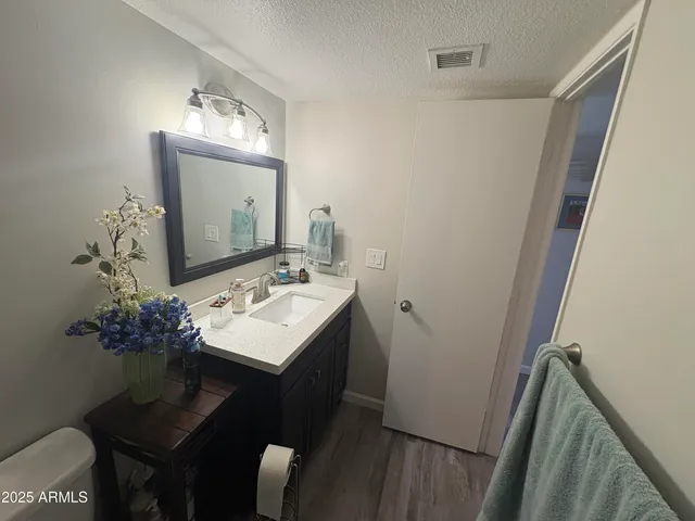a bathroom with a sink toilet and mirror