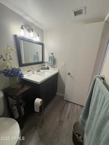a bathroom with a sink mirror and vanity