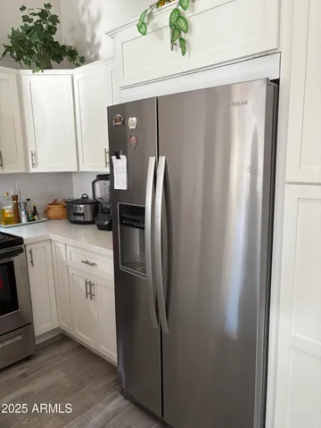 a kitchen with stainless steel appliances granite countertop a refrigerator and a sink