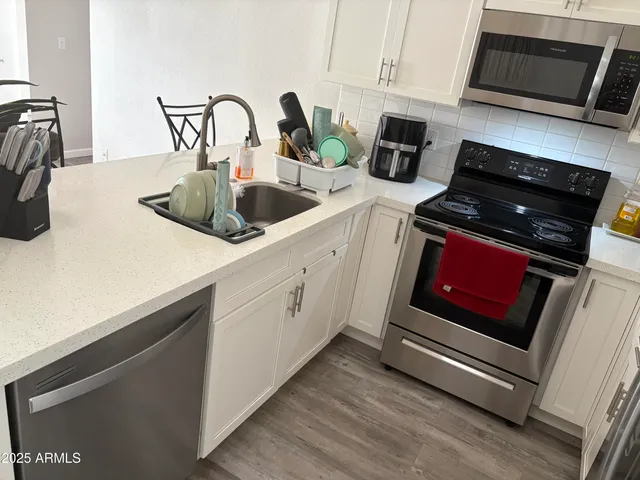 a kitchen with sink a microwave and stove