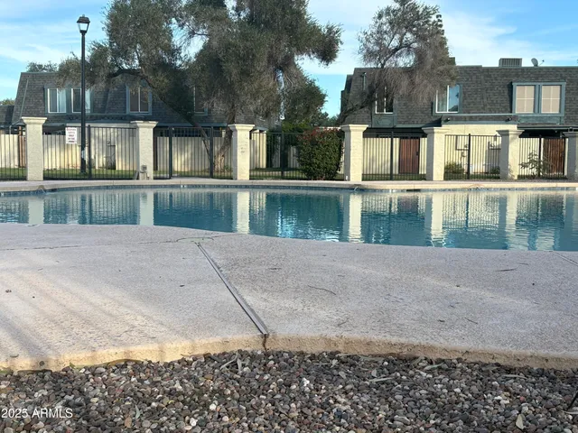 a view of swimming pool with outdoor space and lake view