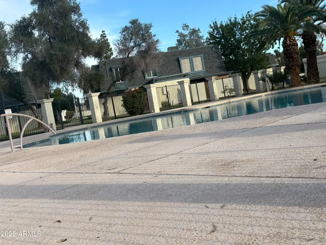 a view of a backyard patio and swimming pool