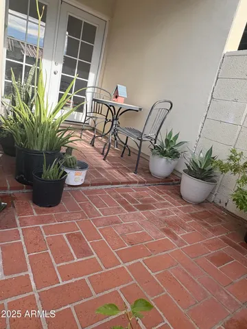 a view of a house with potted plants