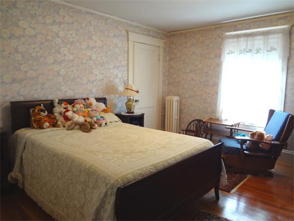 55 Cedar Road Medford, MA 02155 - Photo 14 of 20 a bedroom with a bed and wooden floor