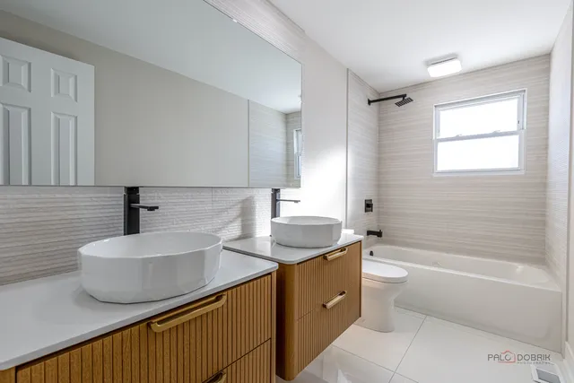 a bathroom with a sink a toilet and bathtub