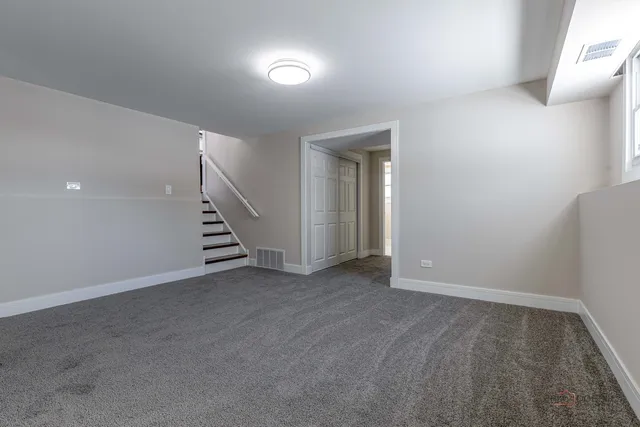 a view of an empty room with stairs