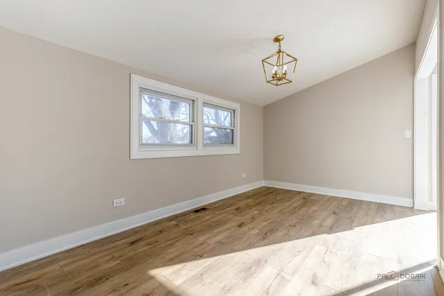a view of a livingroom with wooden floor and a window