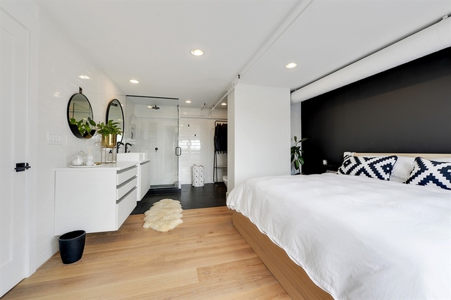 Undisclosed Address Chicago, IL 60607 - Photo 13 of 19 a bedroom with a bed and a flat screen tv