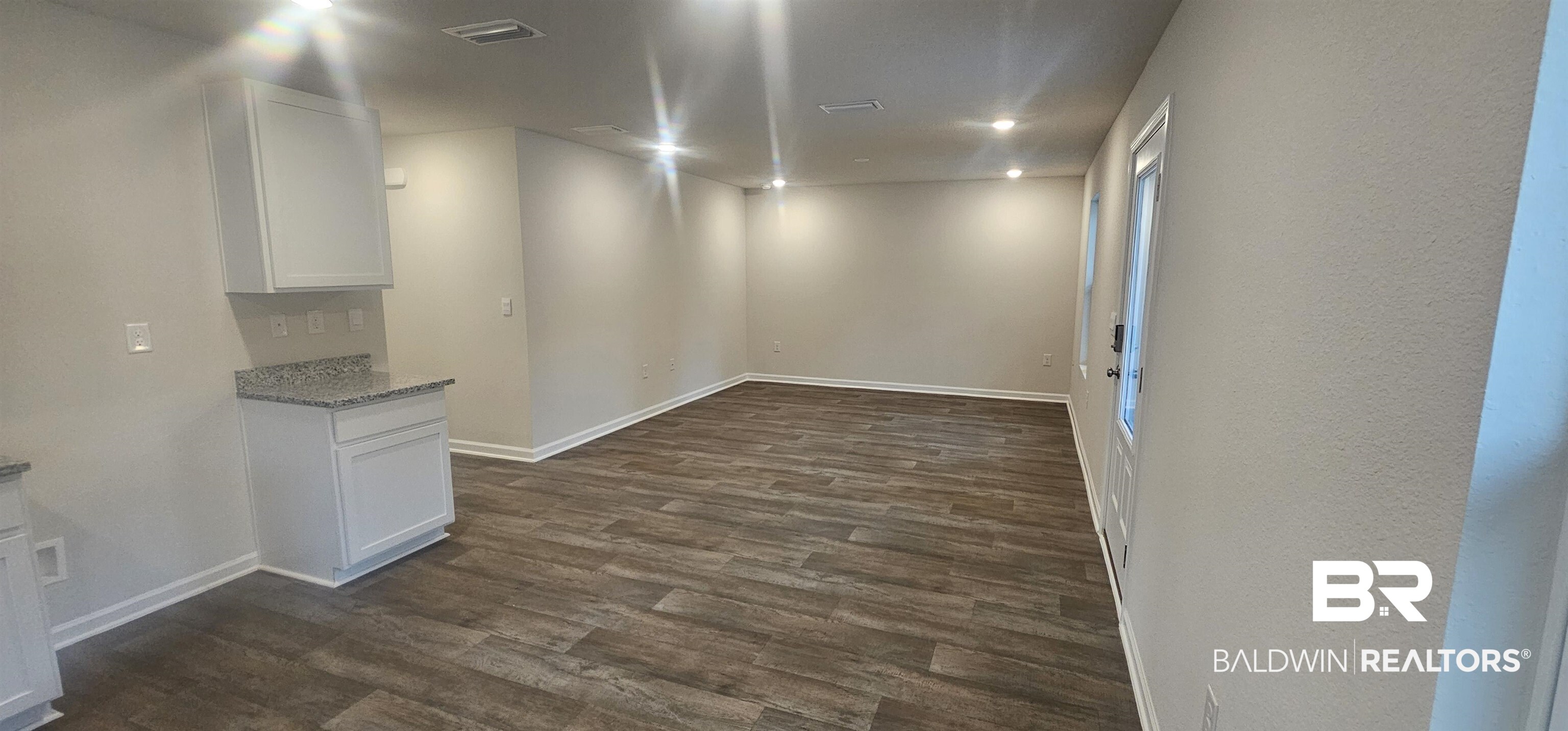 1004 South Bay Street Foley, AL 36535 - Photo 9 of 32 Empty room featuring dark hardwood / wood-style floors