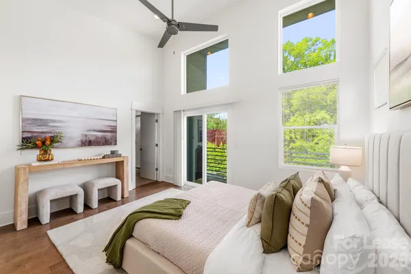 a bed sitting in a bedroom next to a window
