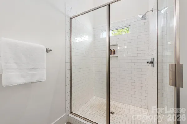 a spacious bathroom with a shower and a sink