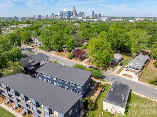 an aerial view of a house with a yard and lake view