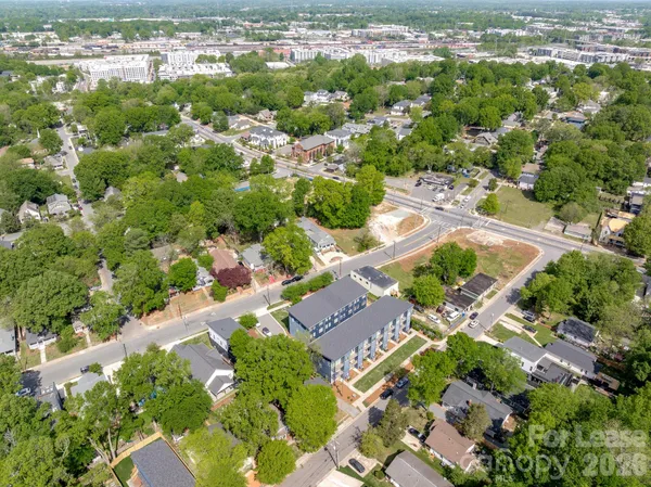 an aerial view of a residential houses with city view