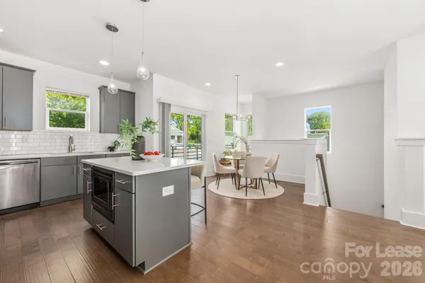 a living room with furniture and kitchen view